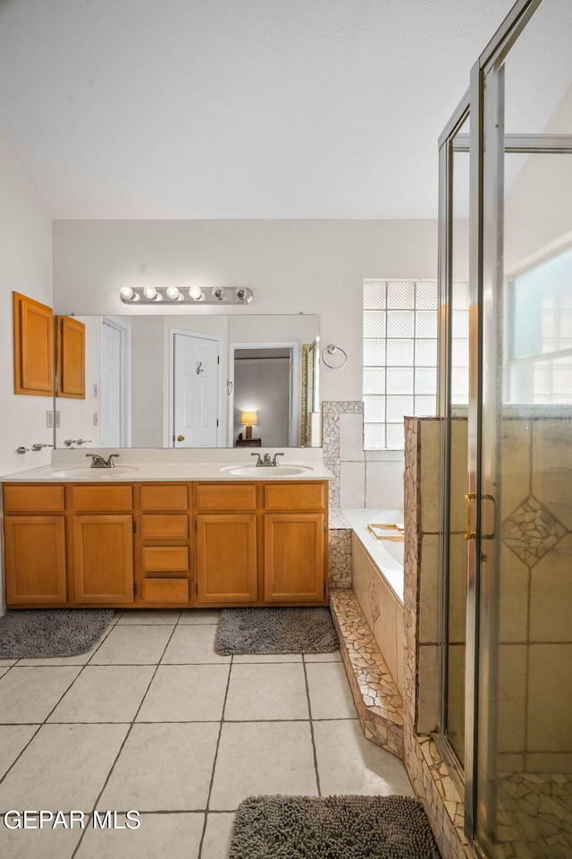 bathroom with vanity, independent shower and bath, and tile patterned flooring