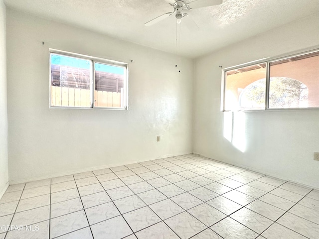 unfurnished room with a textured ceiling and ceiling fan