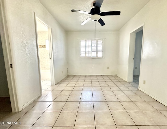 spare room featuring light tile patterned floors and ceiling fan