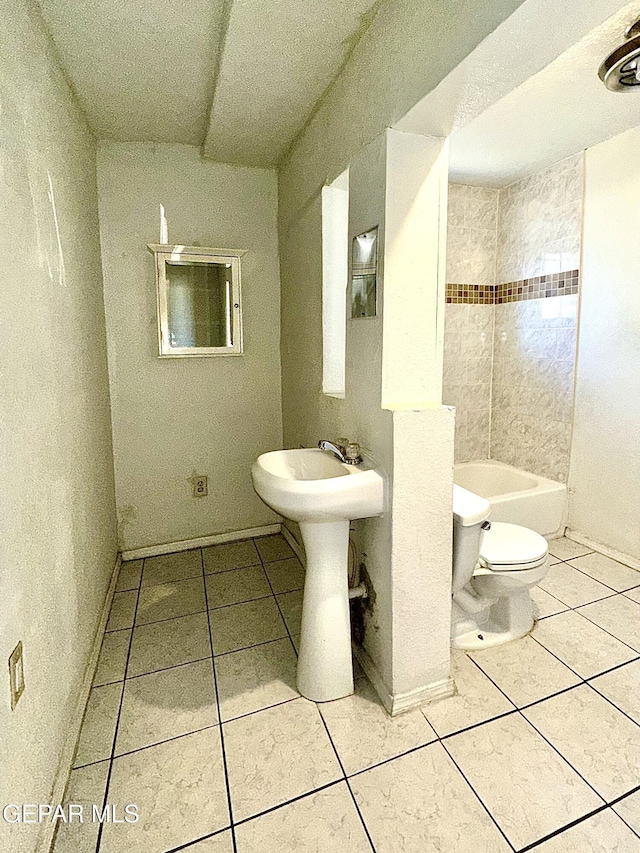 full bathroom with tile patterned flooring, sink, tiled shower / bath combo, and toilet