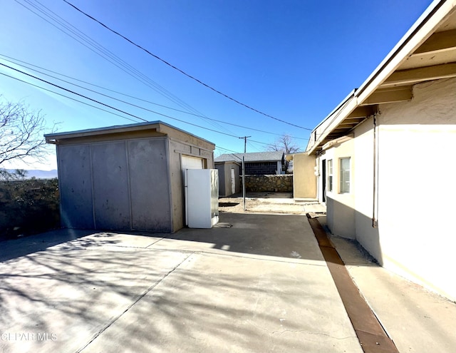 view of patio with a storage unit