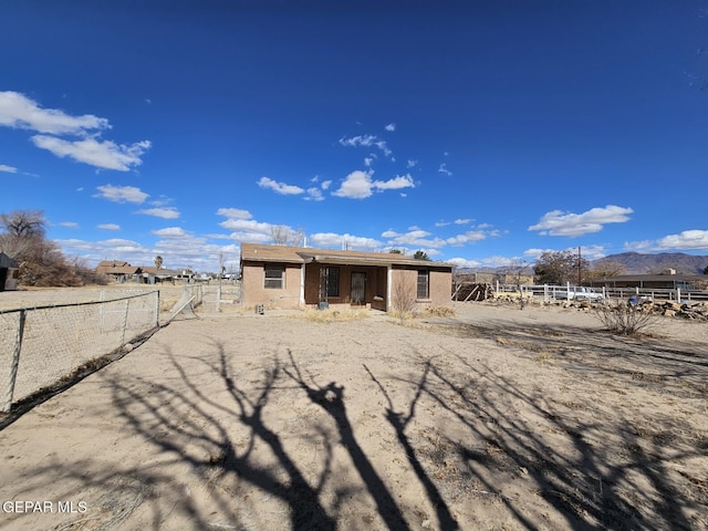 rear view of property featuring a mountain view