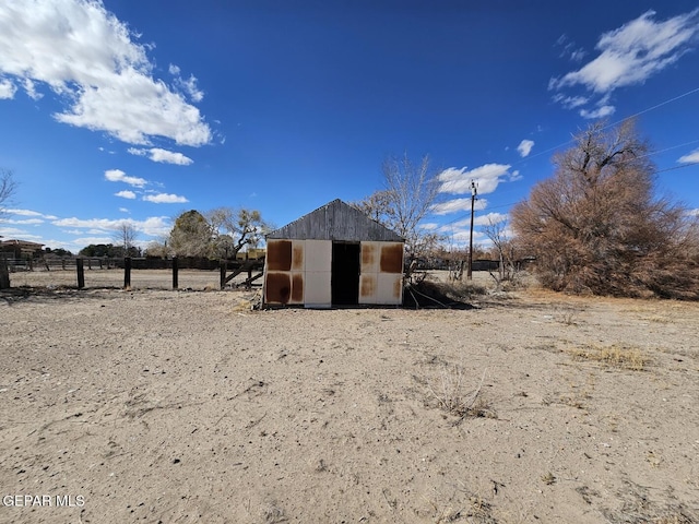 view of outdoor structure with a rural view