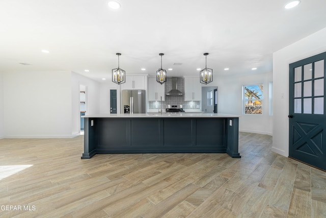 kitchen featuring white cabinetry, a spacious island, stainless steel appliances, and hanging light fixtures