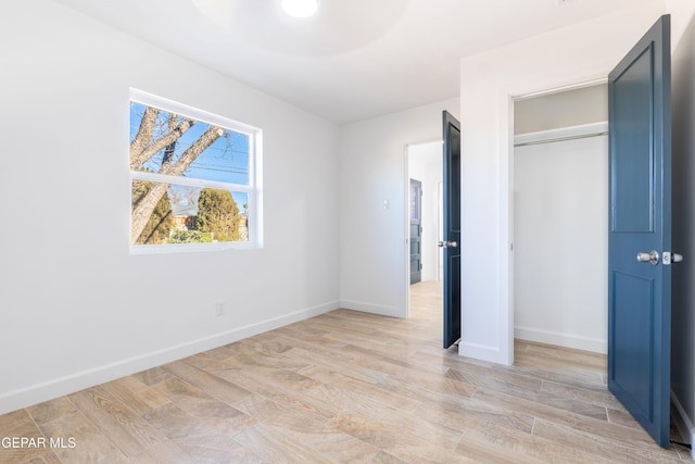 unfurnished bedroom with a closet and light hardwood / wood-style flooring