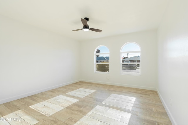 spare room featuring light wood-type flooring and ceiling fan