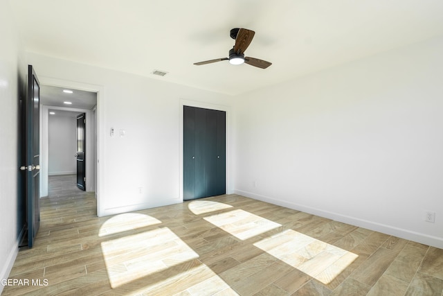 unfurnished room featuring ceiling fan and light wood-type flooring