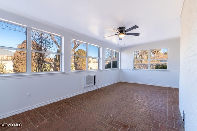 empty room featuring ceiling fan and a wall unit AC