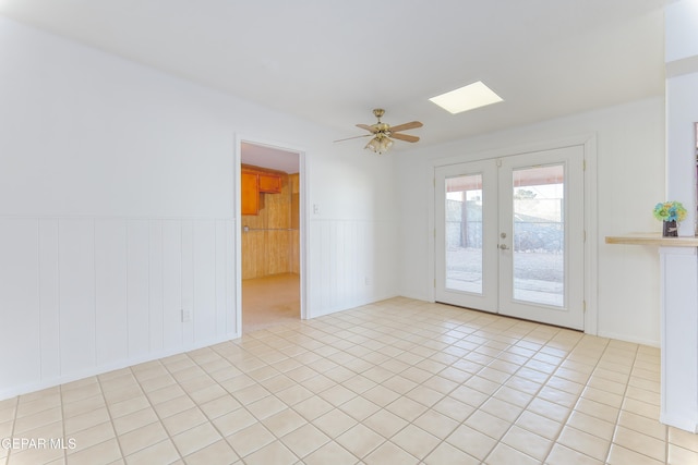 tiled empty room with french doors and ceiling fan