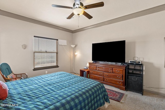 carpeted bedroom with ornamental molding and ceiling fan