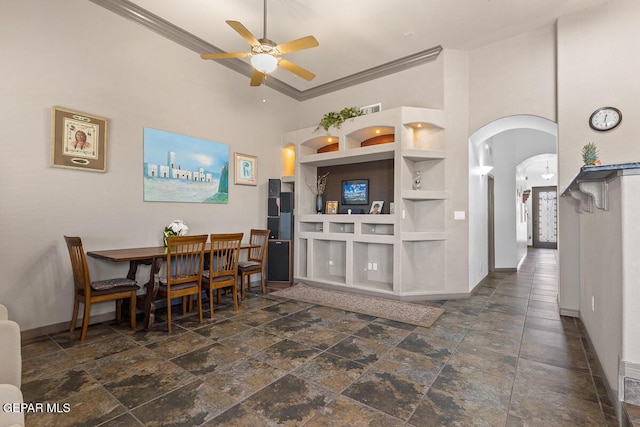 kitchen featuring crown molding, ceiling fan, built in features, and a high ceiling