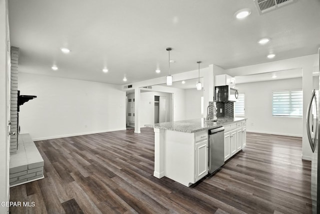 kitchen with white cabinetry, light stone countertops, decorative light fixtures, and stainless steel appliances