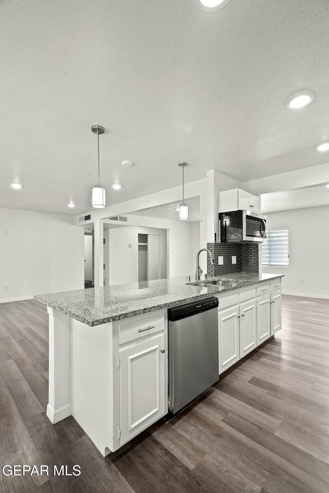 kitchen with white cabinetry, appliances with stainless steel finishes, and pendant lighting