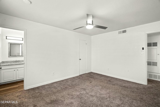 carpeted spare room with sink and ceiling fan