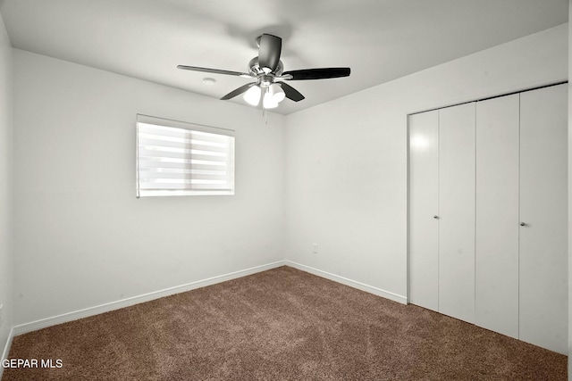 unfurnished bedroom featuring a closet, ceiling fan, and carpet