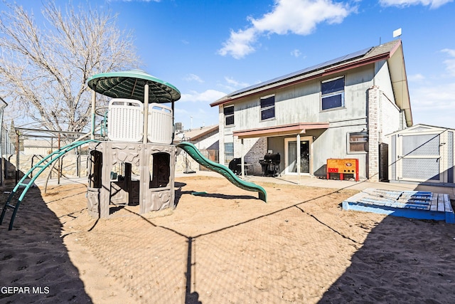 view of jungle gym featuring a storage unit