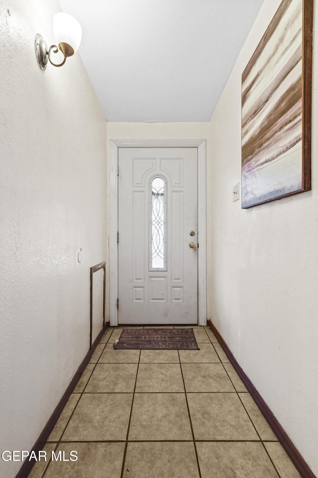 doorway to outside featuring light tile patterned floors