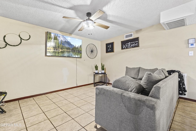 tiled living room featuring a textured ceiling and ceiling fan