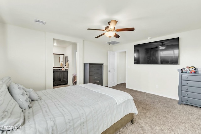 bedroom featuring ensuite bathroom, ceiling fan, and carpet flooring