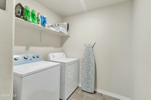 laundry area featuring light tile patterned floors and washer and clothes dryer