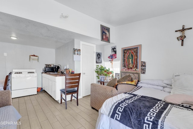 bedroom featuring sink and light hardwood / wood-style floors