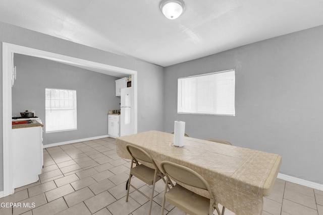 dining area featuring light tile patterned floors