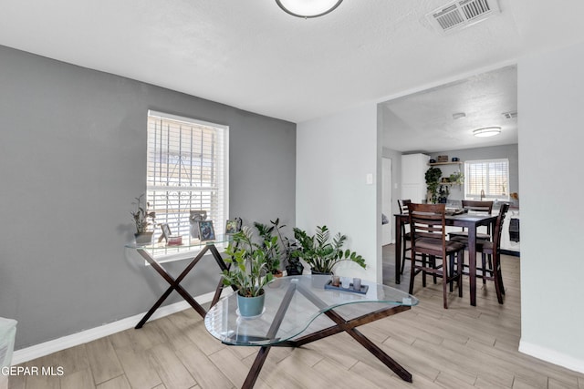 interior space featuring light hardwood / wood-style flooring and a textured ceiling