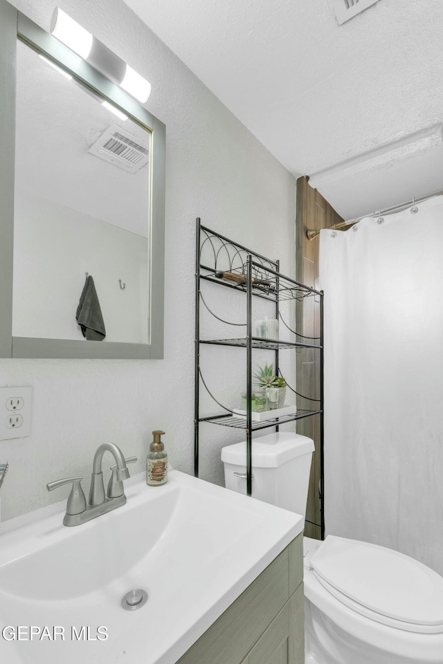 bathroom with vanity, a shower with curtain, and toilet