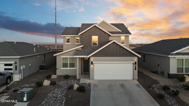 view of front of property with a garage and cooling unit