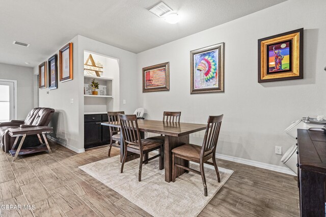 dining space with hardwood / wood-style flooring