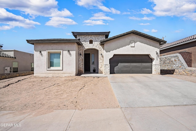 view of front facade with a garage, concrete driveway, stone siding, and stucco siding