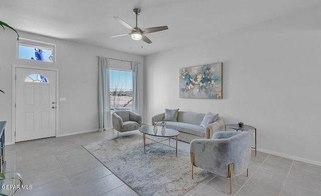 living room with ceiling fan, light tile patterned floors, and a wealth of natural light