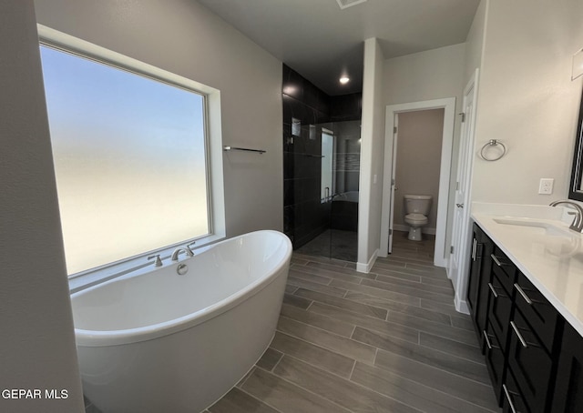 full bathroom featuring vanity, toilet, and shower with separate bathtub