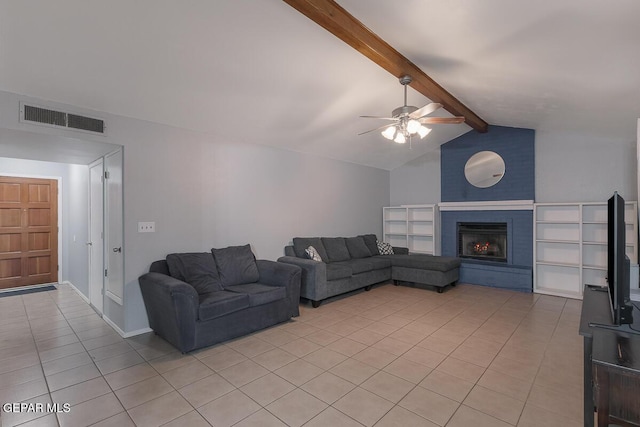 tiled living room with lofted ceiling with beams, a brick fireplace, and ceiling fan