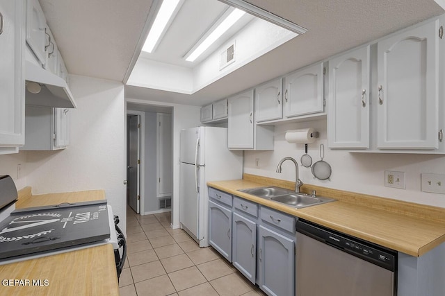 kitchen featuring sink, white cabinetry, range, light tile patterned floors, and dishwasher