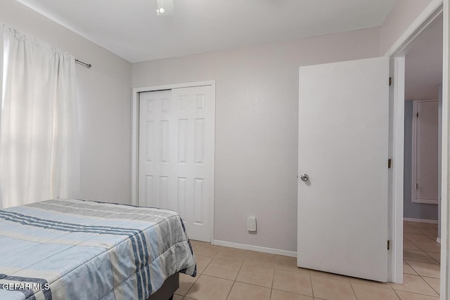 tiled bedroom featuring a closet