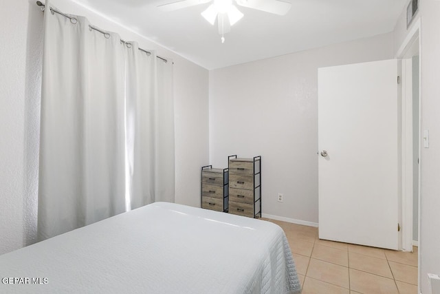 bedroom featuring light tile patterned floors and ceiling fan