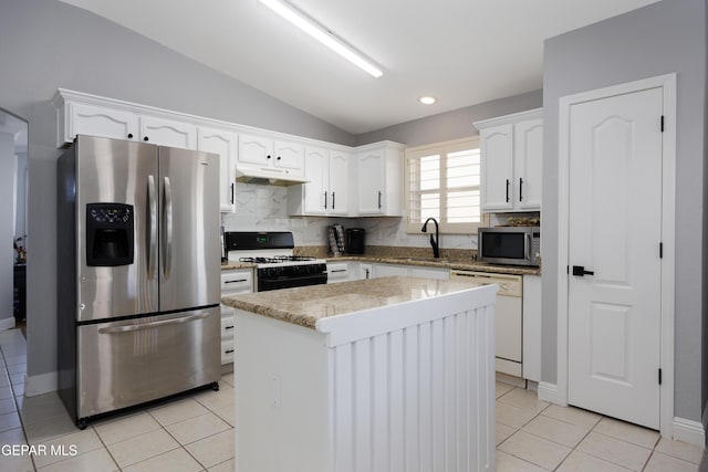 kitchen featuring vaulted ceiling, a kitchen island, appliances with stainless steel finishes, white cabinetry, and sink