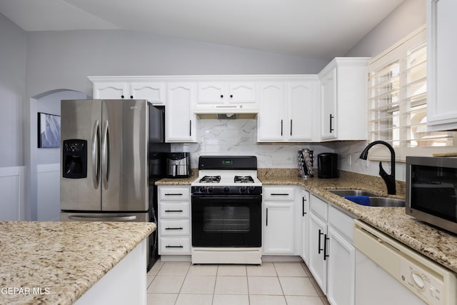 kitchen featuring white cabinetry, appliances with stainless steel finishes, sink, and lofted ceiling