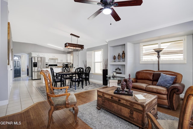 living room featuring vaulted ceiling, ceiling fan, and light hardwood / wood-style floors