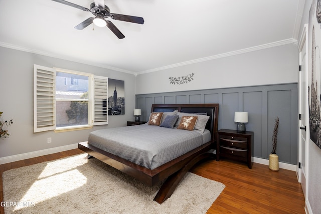 bedroom featuring crown molding, dark wood-type flooring, and ceiling fan