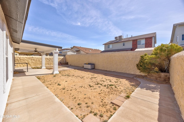 view of yard featuring a patio, ceiling fan, and central air condition unit