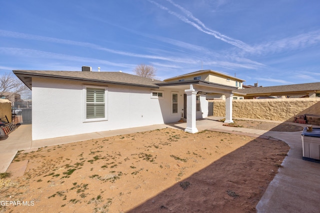 back of property with a patio