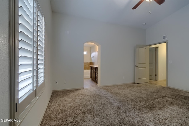 carpeted spare room featuring ceiling fan