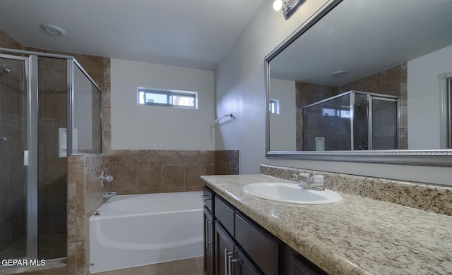 bathroom with vanity, independent shower and bath, and tile patterned flooring