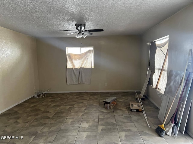 spare room with a textured ceiling and ceiling fan