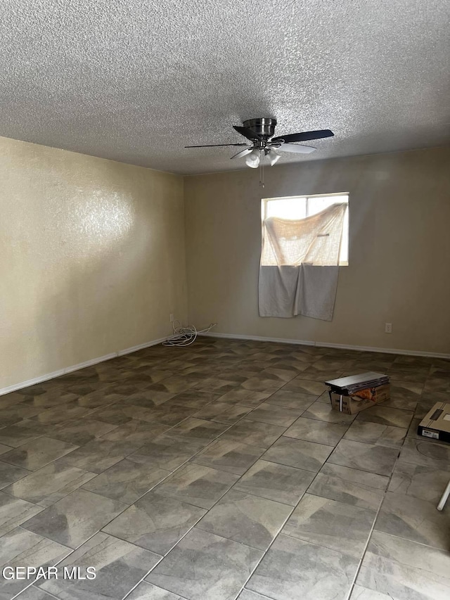 spare room featuring ceiling fan and a textured ceiling