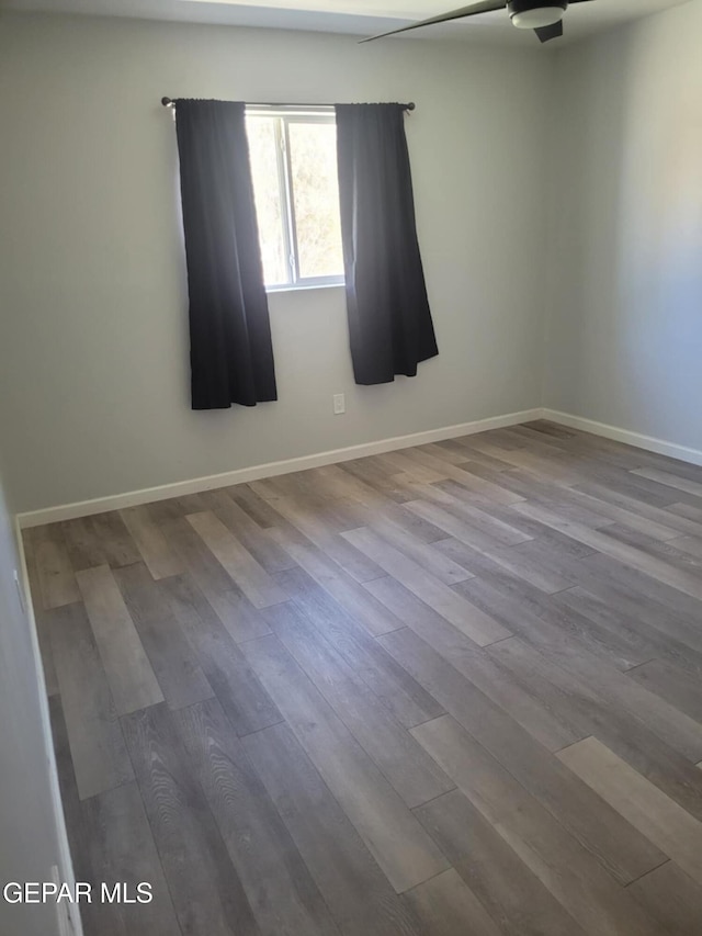 spare room with wood-type flooring