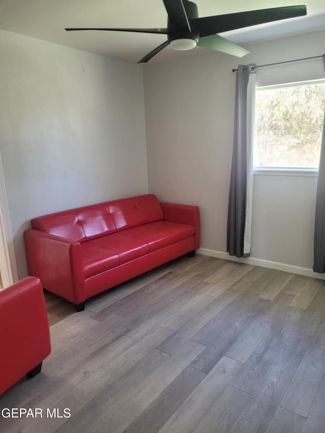 living room featuring hardwood / wood-style flooring and ceiling fan