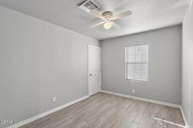 unfurnished room with a textured ceiling, ceiling fan, and light hardwood / wood-style flooring